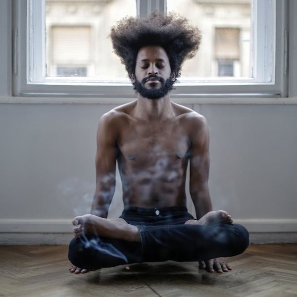 Person in a meditative pose feeling balanced and calm.